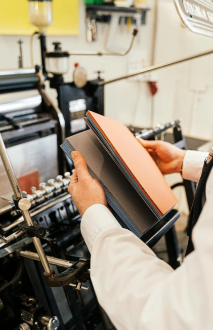 A person looking at printing material