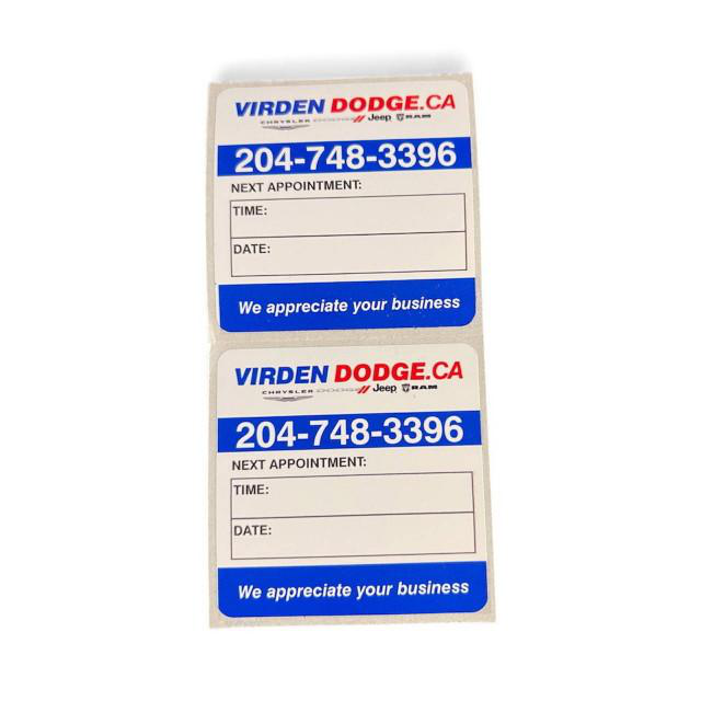 Oil change and service labels use a light, removable adhesive designed not to leave residue on a windshield.
