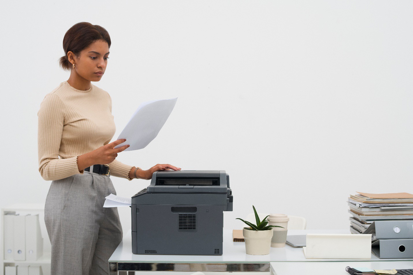 A picture of a person using a printer in office